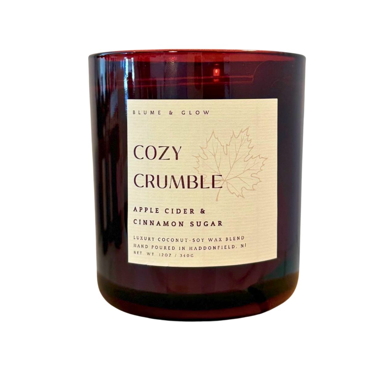 Blume & Glow Cozy Crumble candle with wooden wick in translucent wine jar