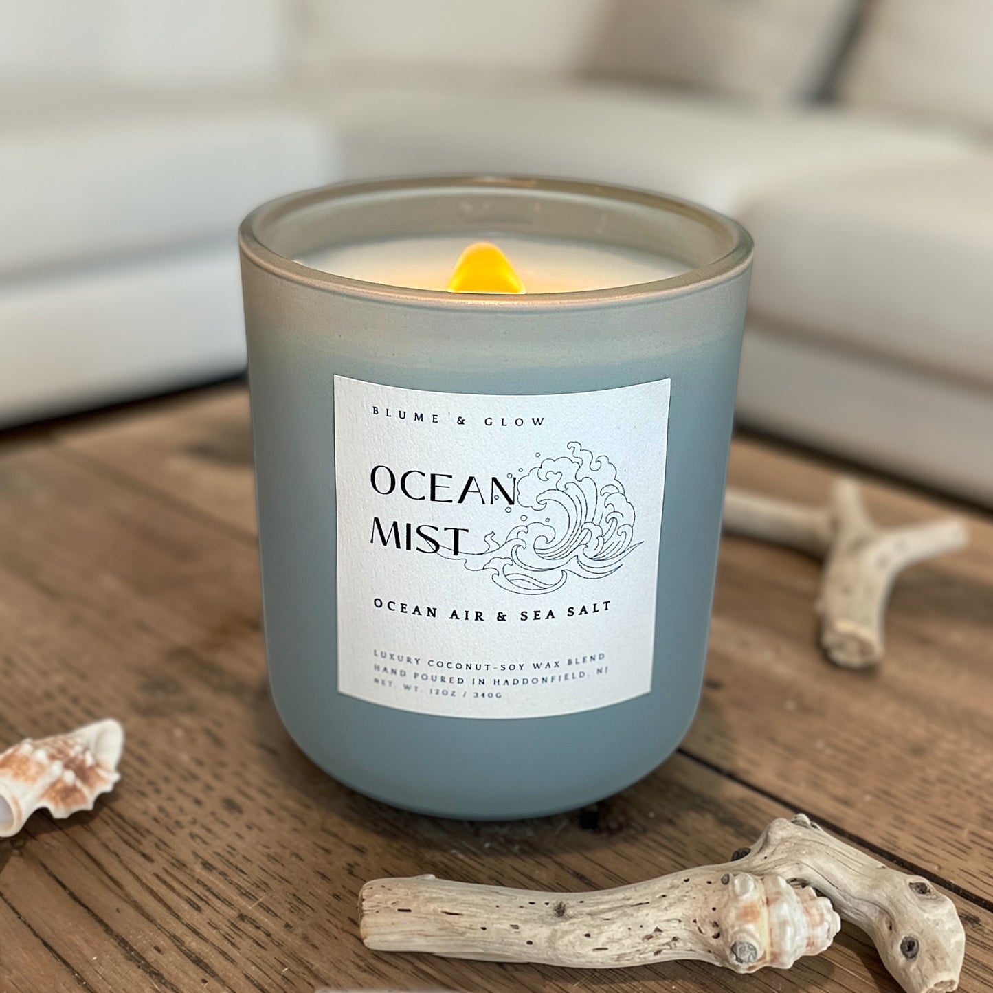 Ocean Mist coastal candle by Blume & Glow burning with crackling wooden wick, cardamom orange peel and sea salt fragrance