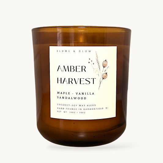 Amber Harvest maple cinnamon and vanilla autumn candle by Blume & Glow with wooden wick in a translucent amber jar