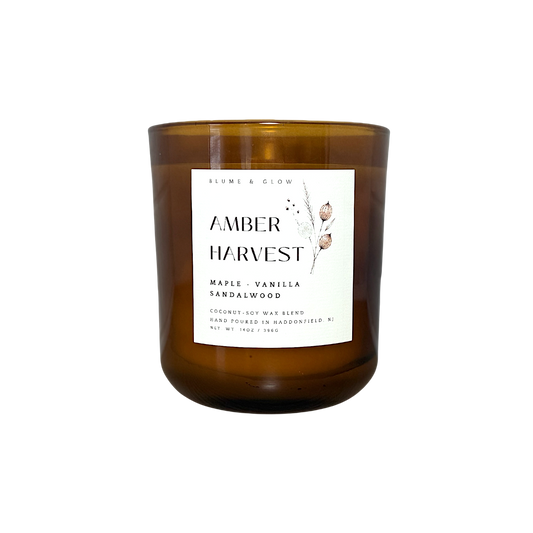 Amber Harvest maple cinnamon and vanilla autumn candle by Blume & Glow with wooden wick in a translucent amber jar