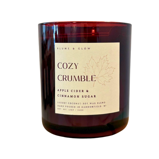 Blume & Glow Cozy Crumble candle with wooden wick in translucent wine jar