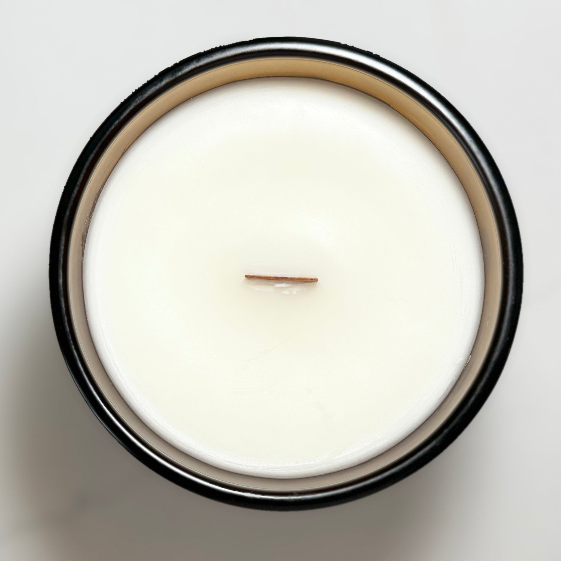 Top view of the Cozy Crumble candle featuring a natural wooden wick and creamy coconut-soy wax.