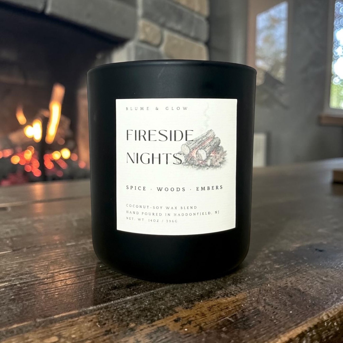 Fireside Nights candle in a cozy living room by the fire giving cool weather vibes