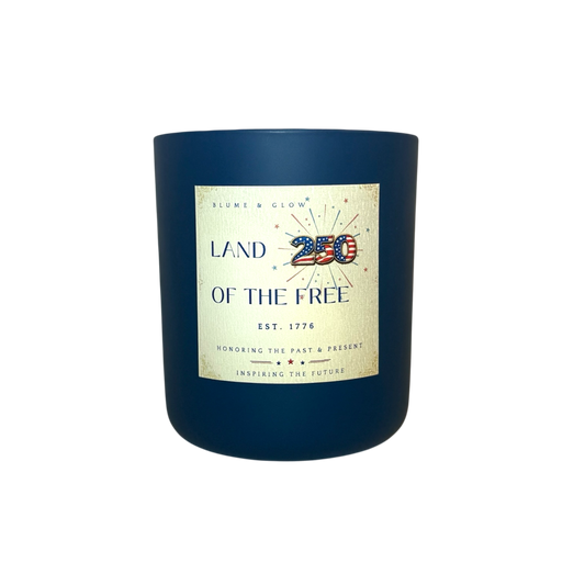 Land of the Free America 250 commemorative candle by Blume & Glow in a navy blue jar with wooden wick and smoky sandalwood fragrance