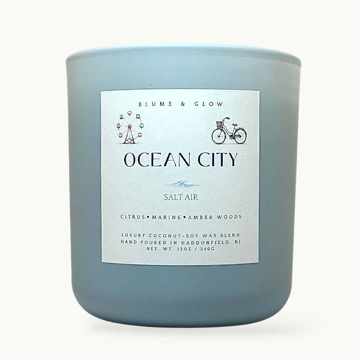 Ocean City NJ inspired candle by Blume & Glow with fresh coastal citrus scent, wooden wick, and coconut-soy wax in a matte blue jar 