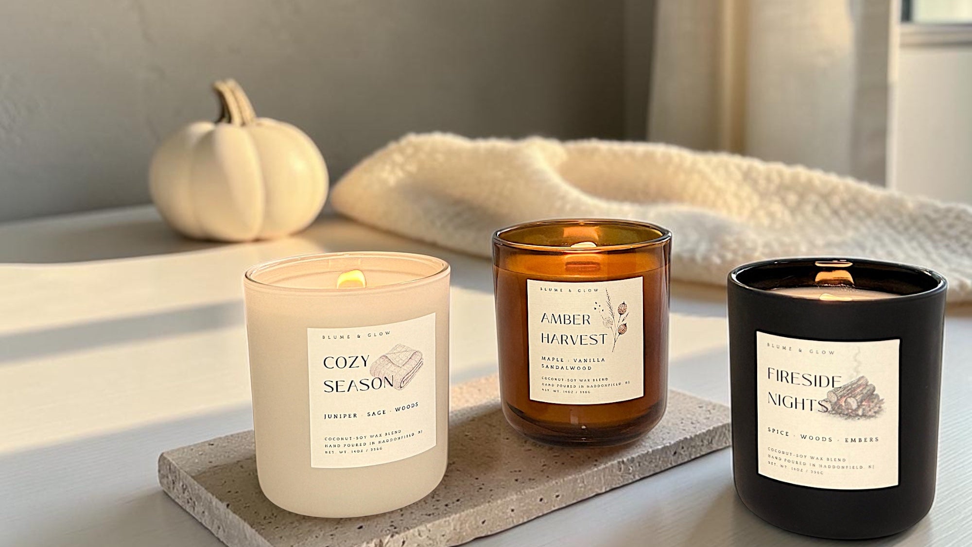 Blume & Glow luxury autumn candle collection featuring Cozy Season, Amber Harvest, and Fireside Nights.